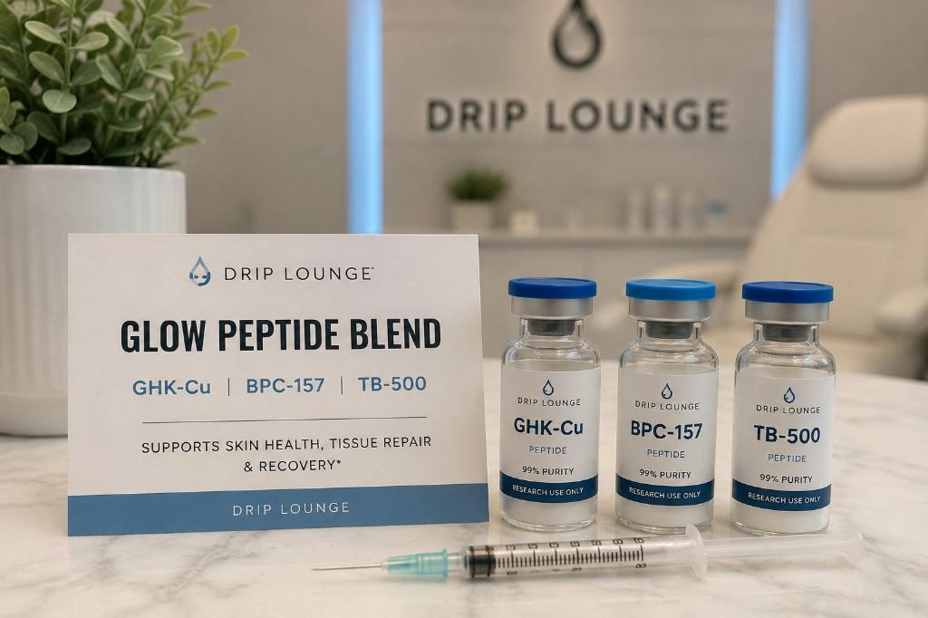 GLOW Peptide Blend vials of GHK-Cu, BPC-157 and TB-500 with syringe on a marble counter at Drip Lounge